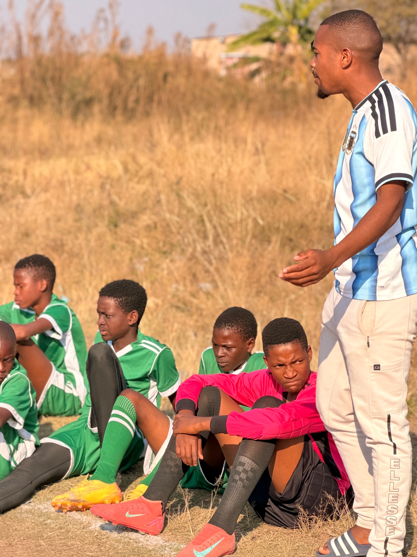 A CM Banda coach mentoring young football players